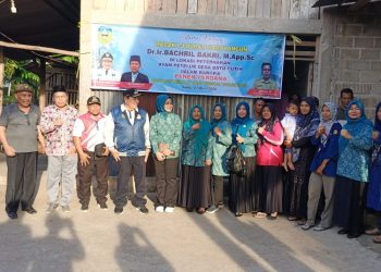 Pj Bupati Sarolangun, Bachril Bakri melakukan panen ayam petelur di Desa Batu Putih. (Foto. Awan).